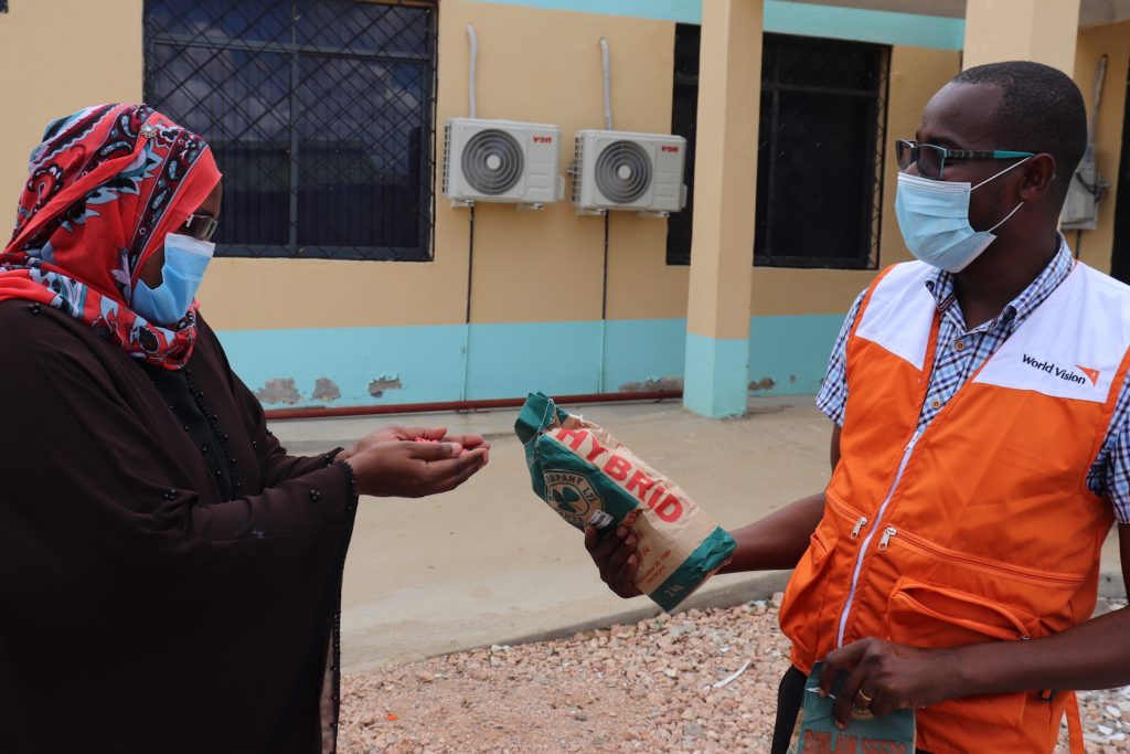 Mwanajuma Hiribae the Tana River County Executive Committe Member CEC for Agriculture receives samples of the seeds from World Vision.©World Vision Photo.