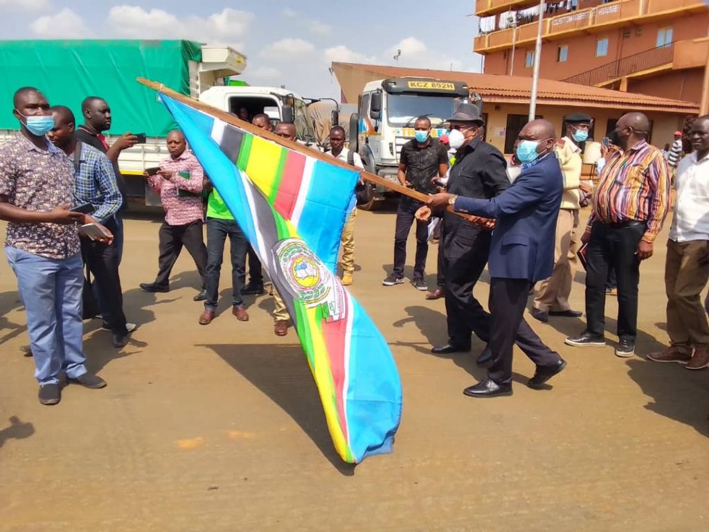 PS Owino flags off a truck carrying fish destined to the Democratic Republic of Congo at the Busia Customs point in Uganda