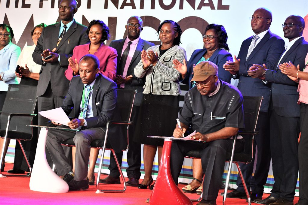 Makueni Governor Mutula Kilonzo Jr and Cornelly Serem Chairman Agriculture and Food Authority Board signing the Communique at the end of the conference min