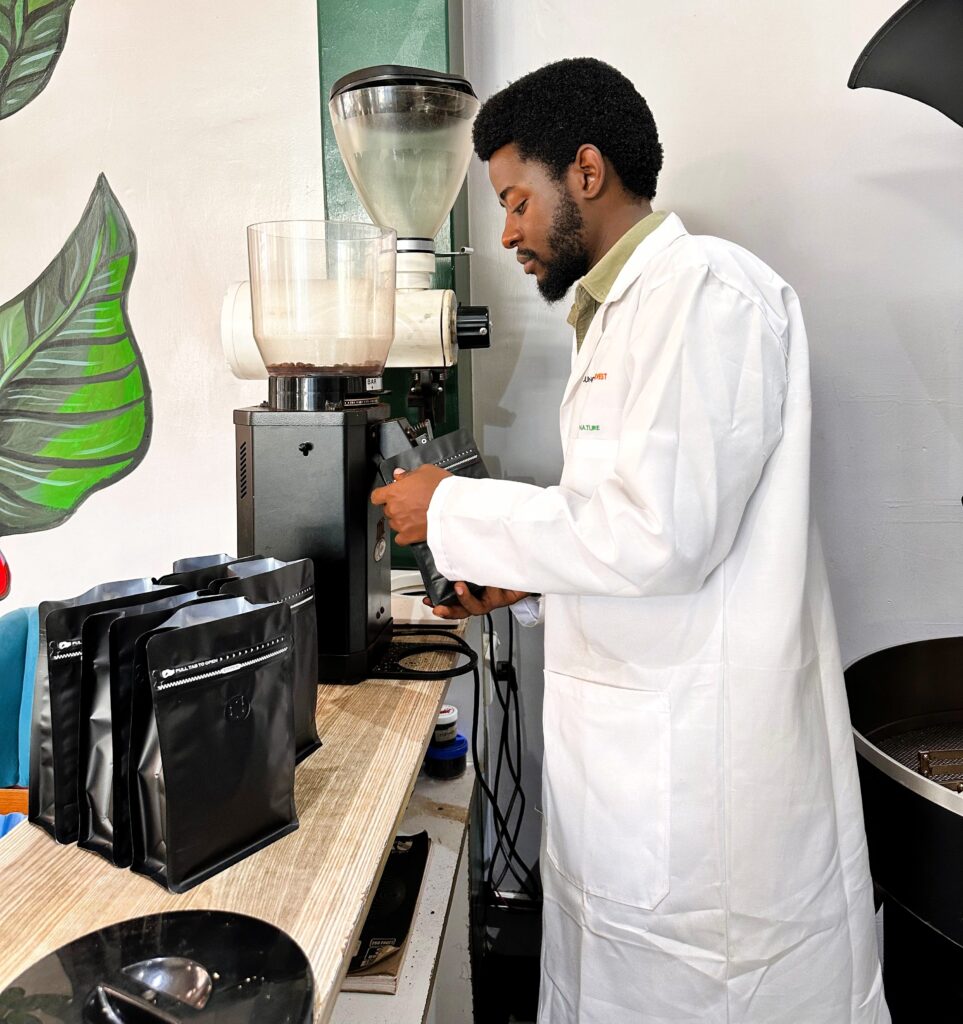 John kamau packaging coffee at the jungle harvests coffee ltd