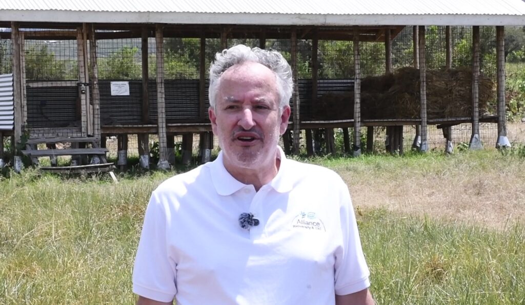 Carlo Fadda Research Lead on Biodiversity for Food and Agriculture at the Alliance of Bioversity International and CIAT at the farm. Behind him is the animal feed conservation unit